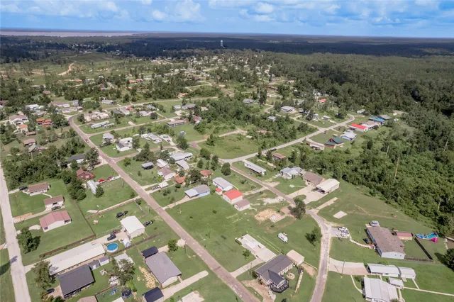 an aerial view of a house with a lake view