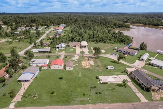 an aerial view of a city with lots of residential buildings ocean and mountain view in back