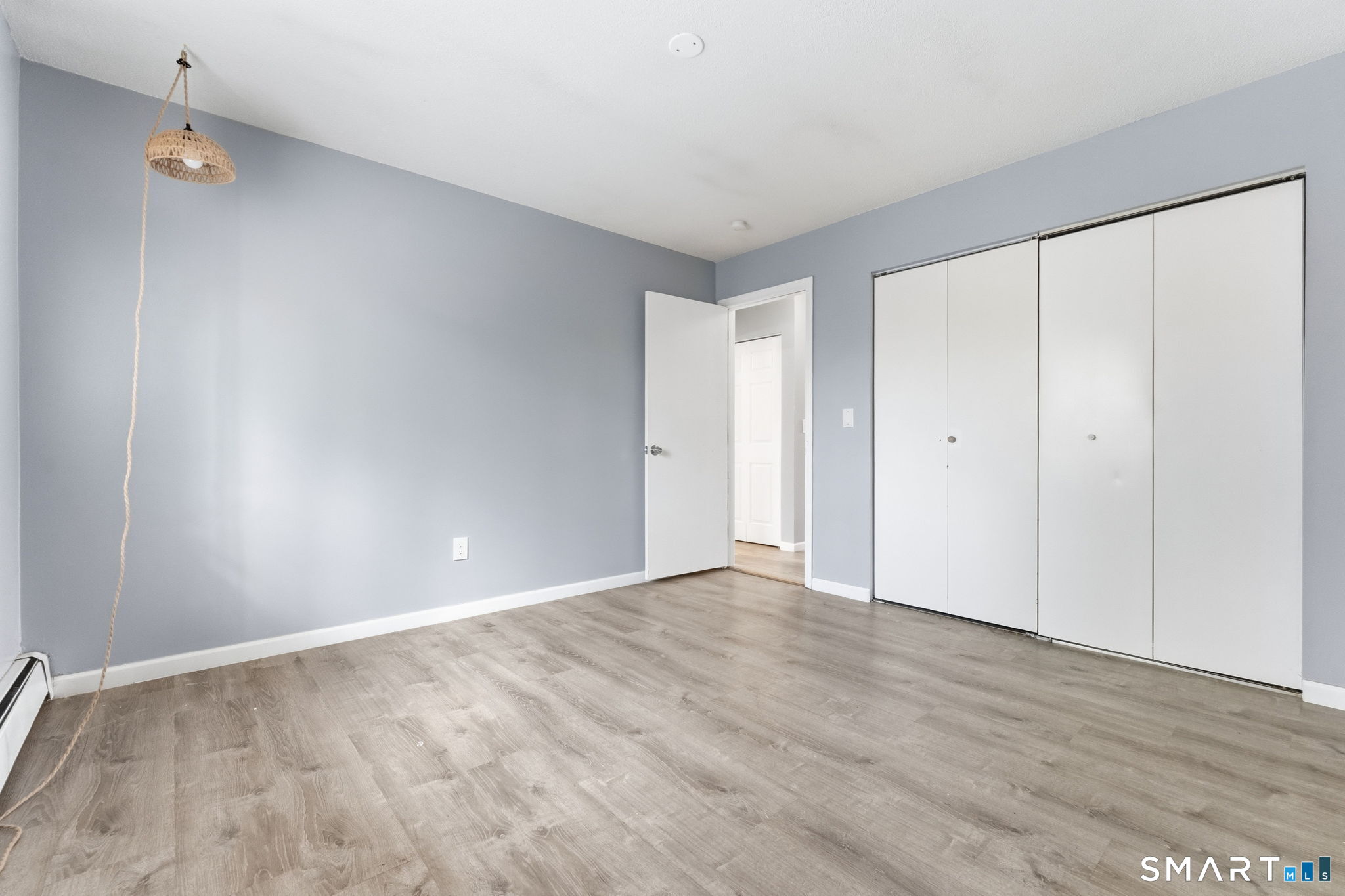 5-7 Warner St Extension, Unit 5B Hartford, CT 06114 - Photo 10 of 17 a view of an empty room with wooden floor