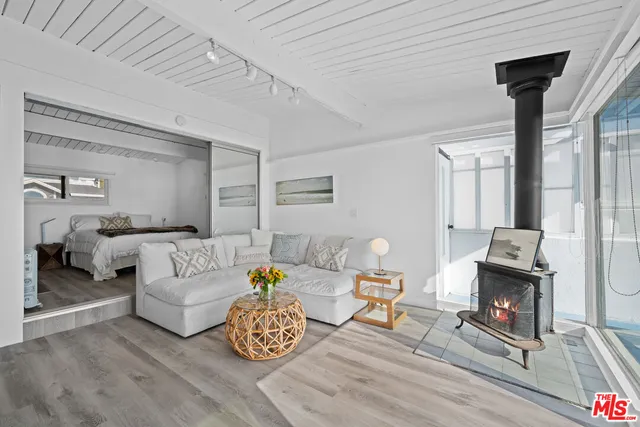 a living room with a wooden floor and a fireplace