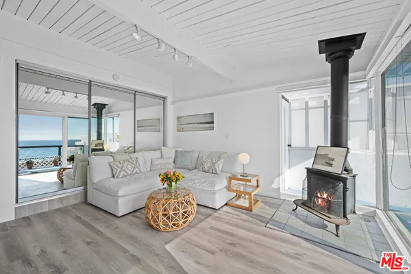 a kitchen with stainless steel appliances kitchen island granite countertop a sink a stove and white cabinets