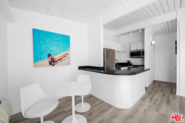 a living room with a wooden floor and a fireplace