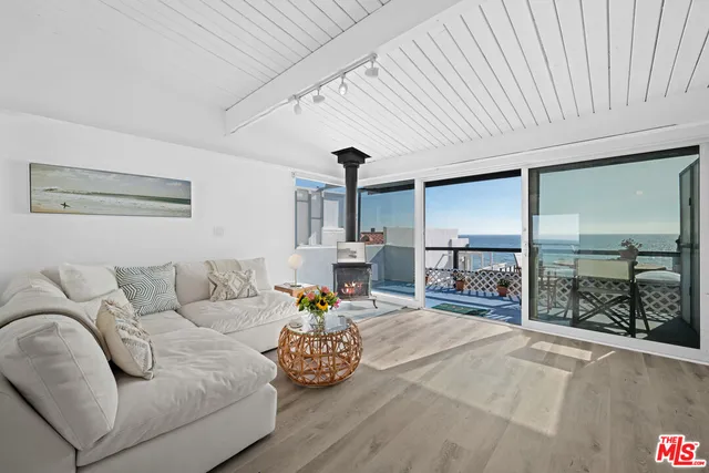 a living room with furniture and a floor to ceiling window