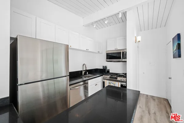 a close view of a stove a microwave and cabinets