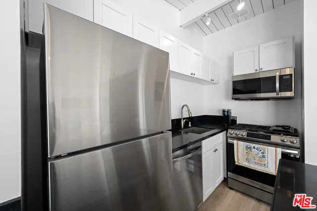 a bedroom with a bed and a night stand