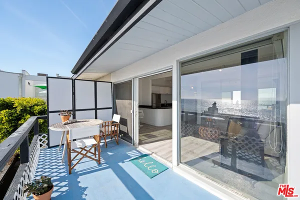 a hallway with table and chairs