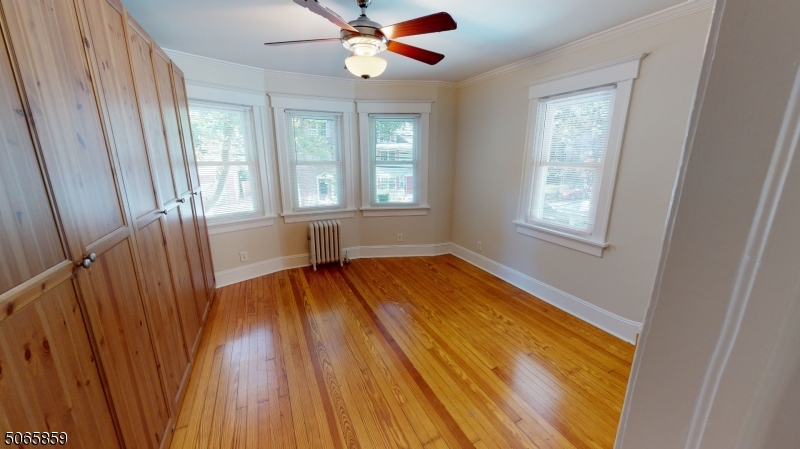 40-42 Dunnell Road Maplewood, NJ 07040 - Photo 12 of 18 a view of an empty room with wooden floor and a window