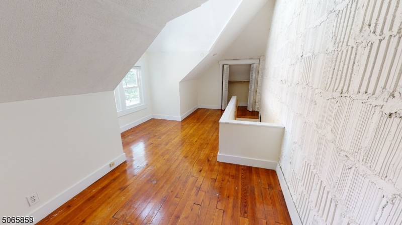 40-42 Dunnell Road Maplewood, NJ 07040 - Photo 13 of 18 a view of a hallway with wooden floor and entryway