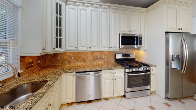 40-42 Dunnell Road Maplewood, NJ 07040 - Photo 3 of 18 a kitchen with granite countertop a sink stove and refrigerator