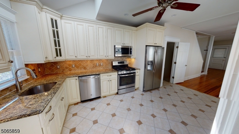 40-42 Dunnell Road Maplewood, NJ 07040 - Photo 4 of 18 a kitchen with stainless steel appliances granite countertop a sink stove and refrigerator