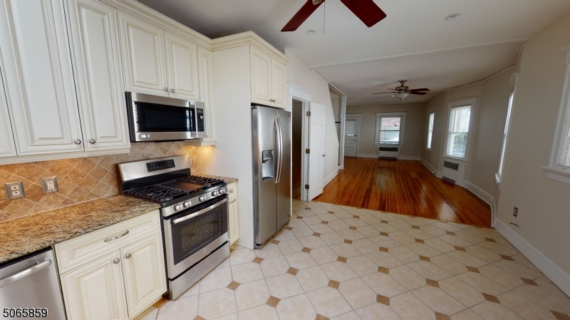 40-42 Dunnell Road Maplewood, NJ 07040 - Photo 5 of 18 a kitchen with stainless steel appliances a stove a sink and a refrigerator