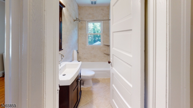 40-42 Dunnell Road Maplewood, NJ 07040 - Photo 8 of 18 a bathroom with a bathtub sink and toilet