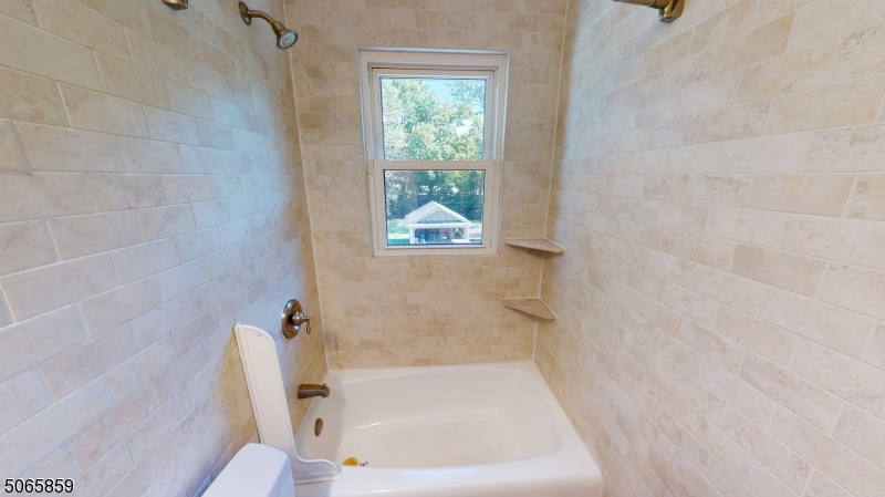 40-42 Dunnell Road Maplewood, NJ 07040 - Photo 10 of 18 a bath tub sitting next to a window