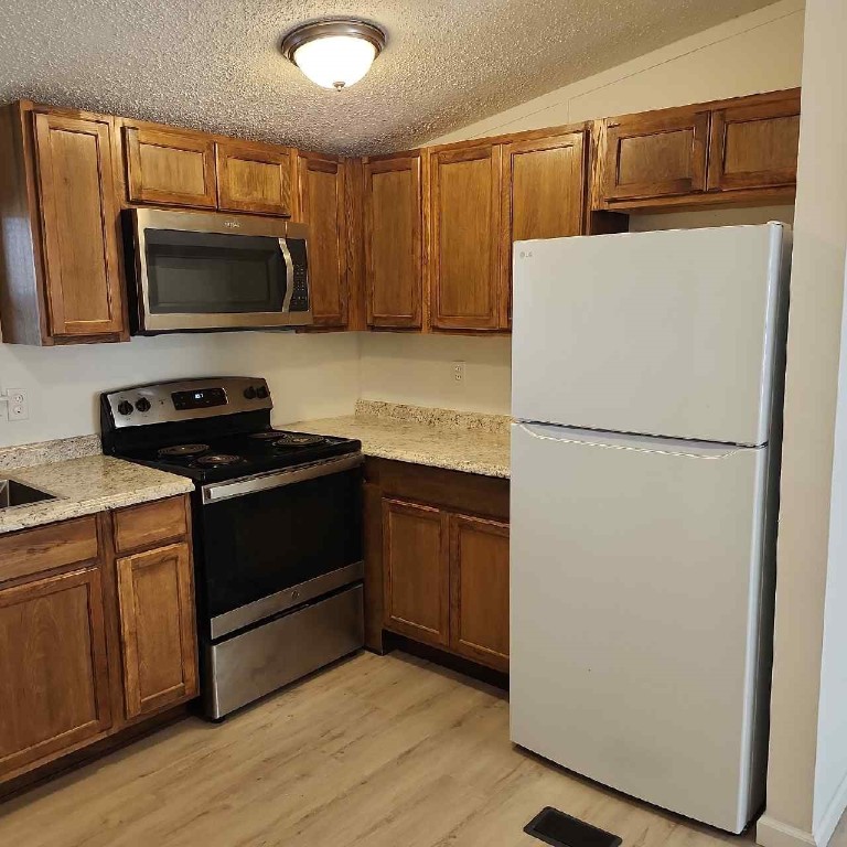 85008 Loretta Lane Yulee, FL 32097 - Photo 8 of 30 a kitchen with a refrigerator sink and microwave