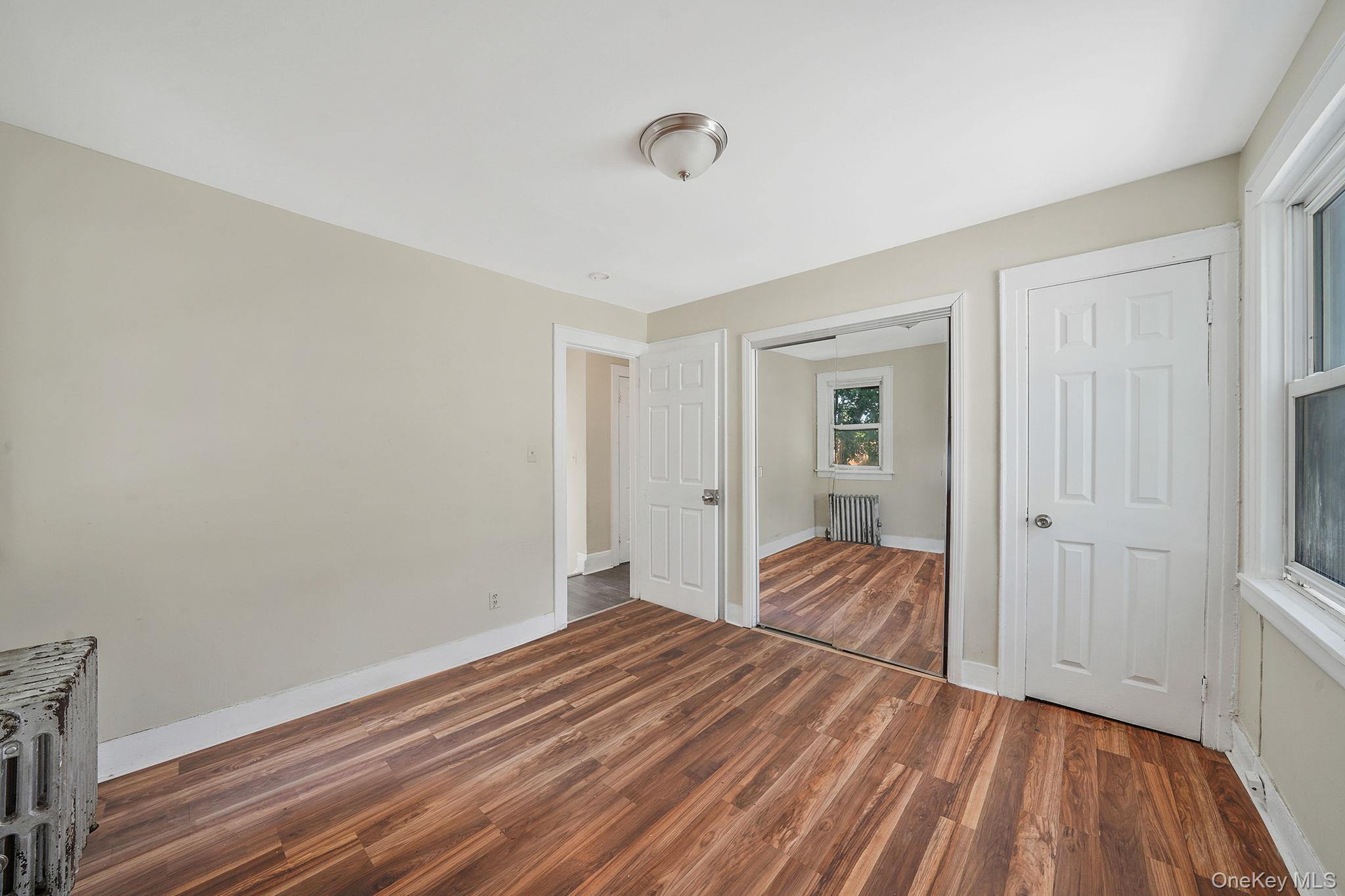 138-41 230th Place Queens, NY 11413 - Photo 11 of 17 a view of a room with wooden floor and natural light