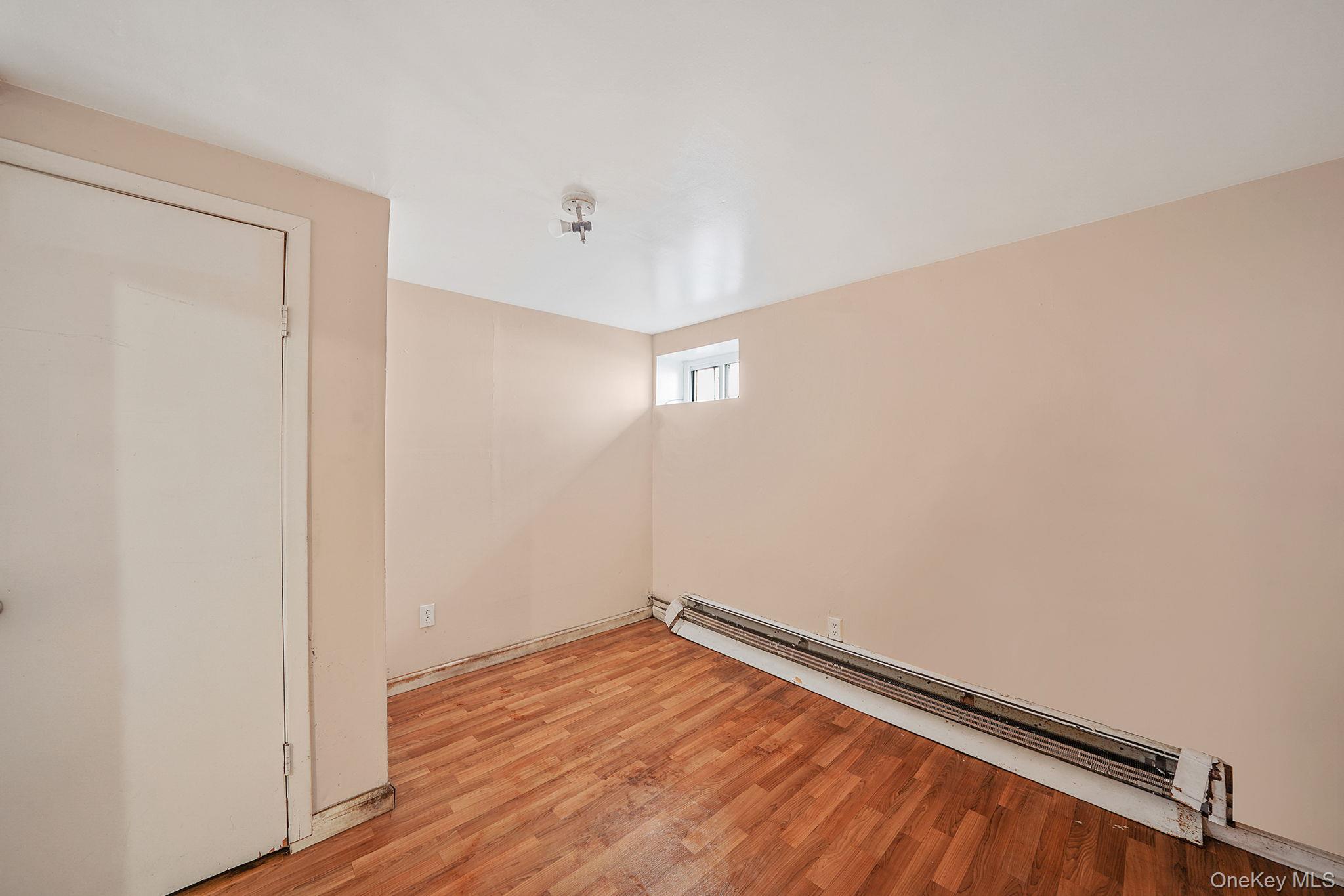 138-41 230th Place Queens, NY 11413 - Photo 14 of 17 a view of empty room with wooden floor