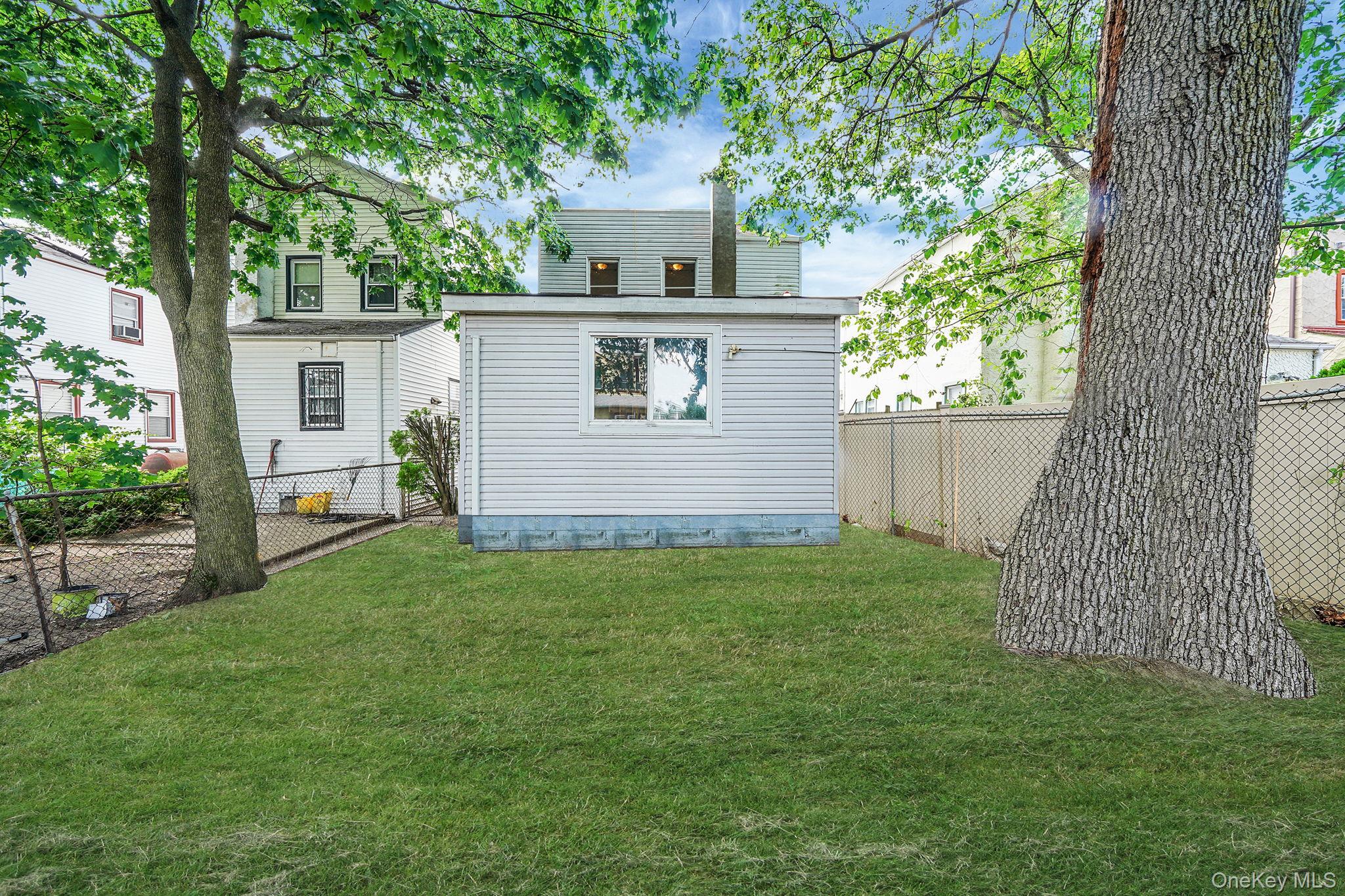 138-41 230th Place Queens, NY 11413 - Photo 4 of 17 a view of backyard of house with green space