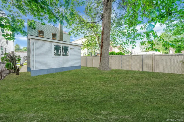 a view of a backyard with a large tree