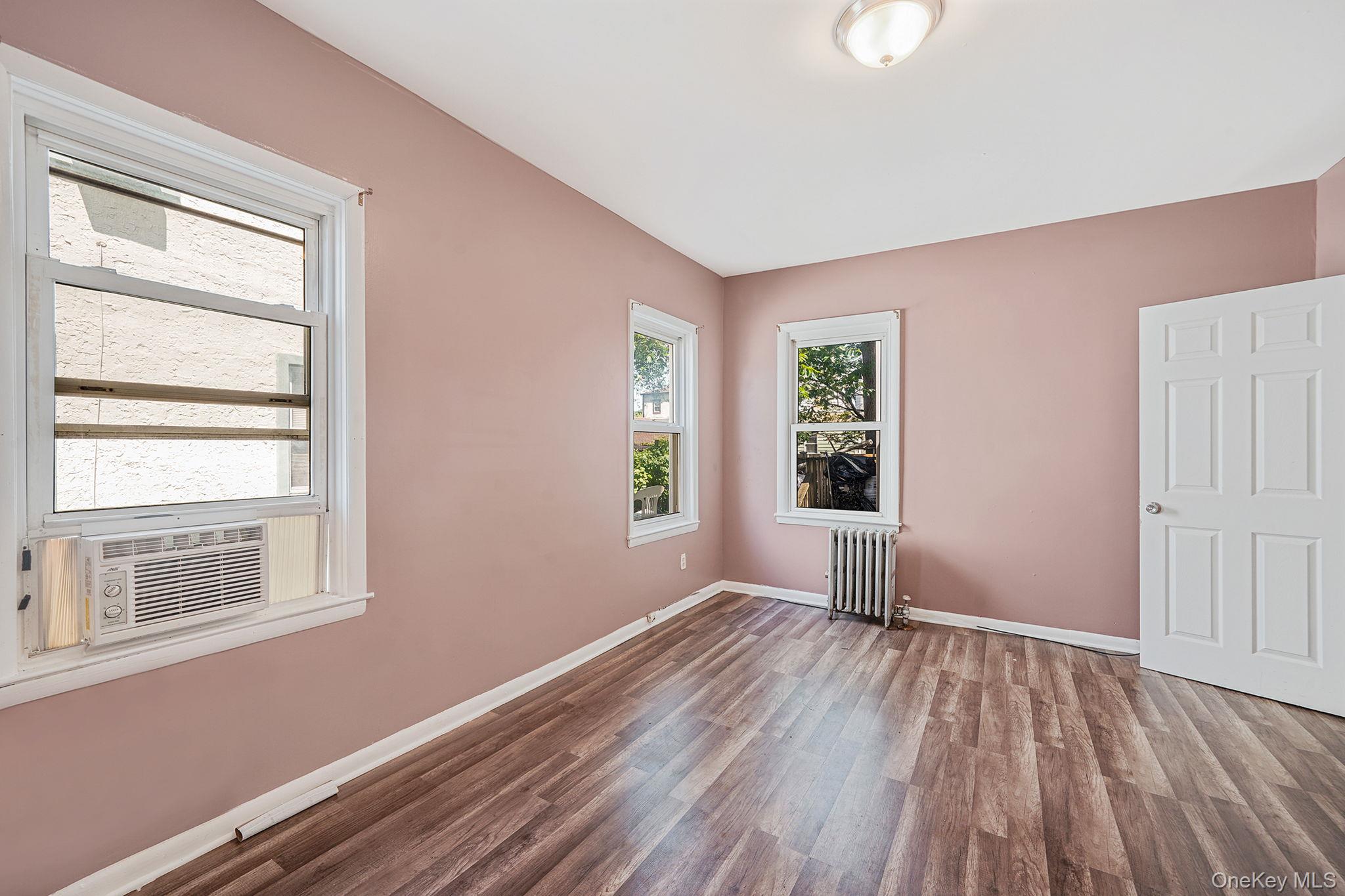 138-41 230th Place Queens, NY 11413 - Photo 8 of 17 a view of empty room with wooden floor and fan