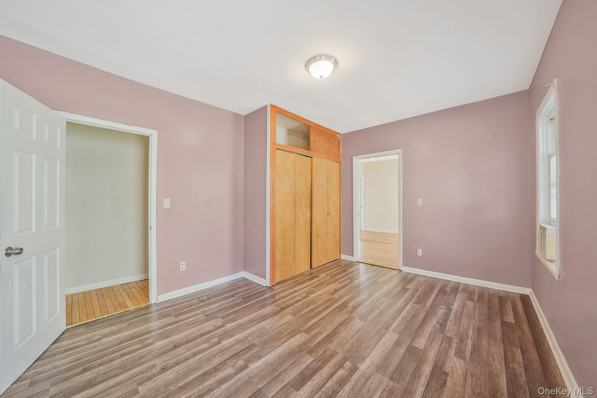 138-41 230th Place Queens, NY 11413 - Photo 9 of 17 a view of an empty room with wooden floor