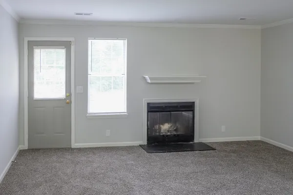 a living room with a fireplace and a window