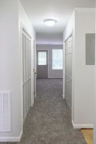 an empty room with windows and closet
