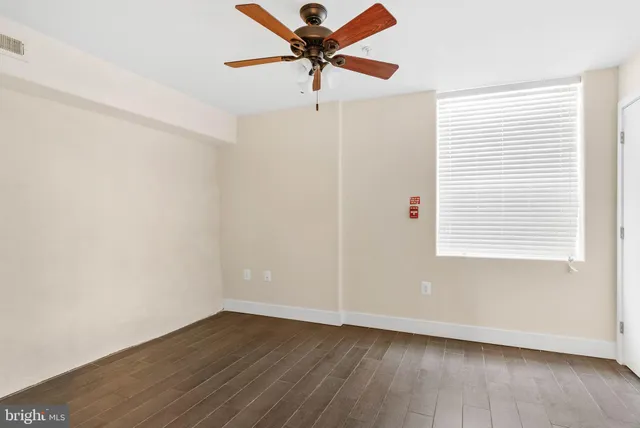 a view of a livingroom with a ceiling fan and wooden floor