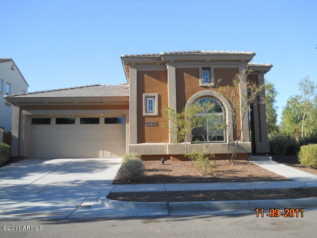 20864 West Ridge Road Buckeye, AZ 85396 - Photo 1 of 37 a front view of a house with garden