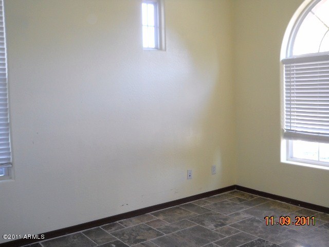 20864 West Ridge Road Buckeye, AZ 85396 - Photo 18 of 37 an empty room with windows