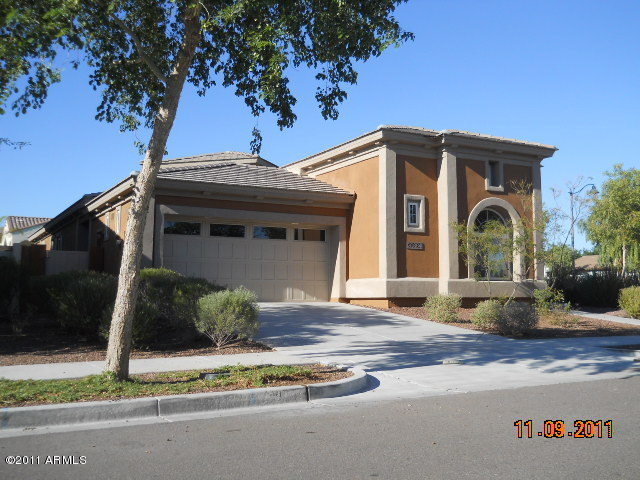 20864 West Ridge Road Buckeye, AZ 85396 - Photo 2 of 37 a front view of a house with a garden