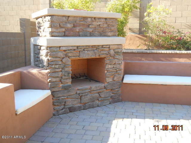 20864 West Ridge Road Buckeye, AZ 85396 - Photo 10 of 37 a living room with furniture and a fireplace