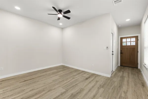 wooden floor in an empty room with a window