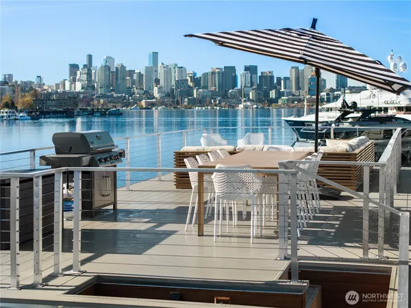a view of a roof deck with lake and city view