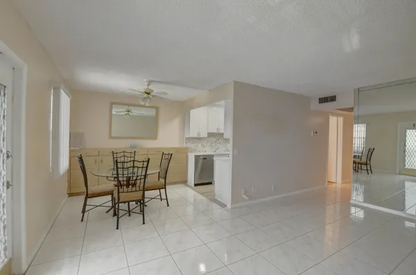 a dining room with furniture and window