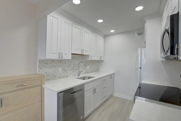 a kitchen with a sink cabinets and refrigerator
