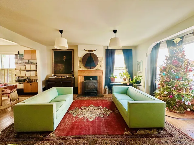 a living room with furniture and a potted plant