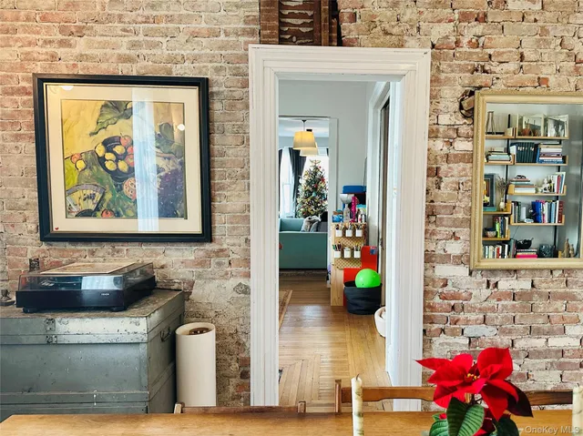 a living room with dining table and wooden floor