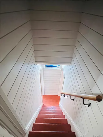 a bedroom with a bed and a book shelf