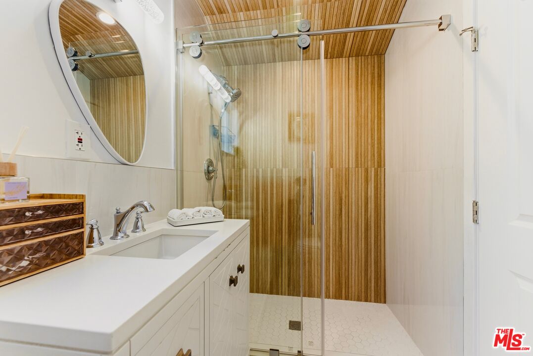 132 North Carson Road, Unit A Beverly Hills, CA 90211 - Photo 12 of 14 a bathroom with a sink and a mirror