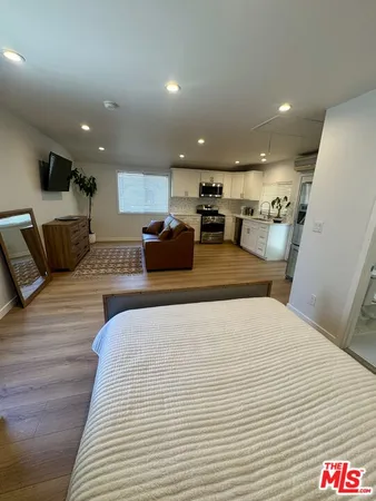 a large bedroom with a bed and furniture