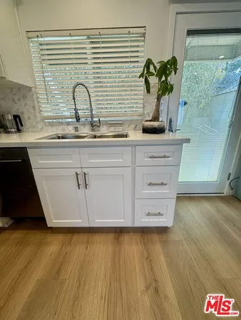 a close view of a sink a counter space and a window