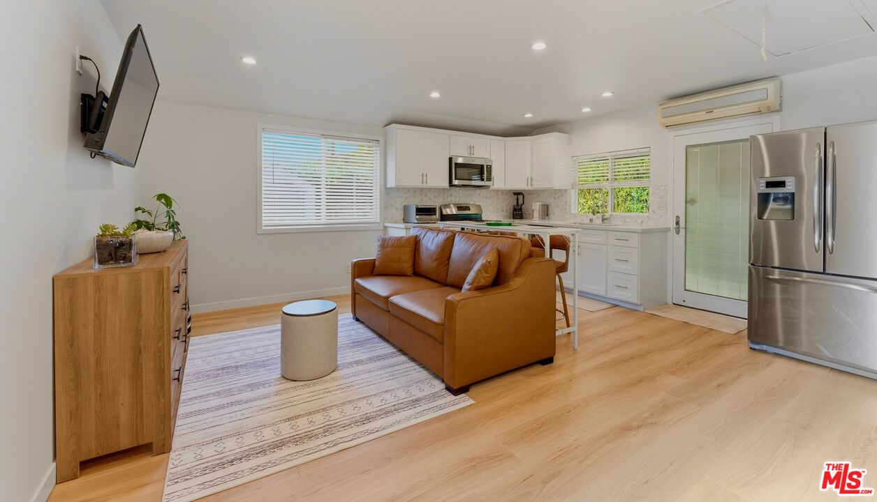 132 North Carson Road, Unit A Beverly Hills, CA 90211 - Photo 5 of 14 a living room with furniture and a wooden floor
