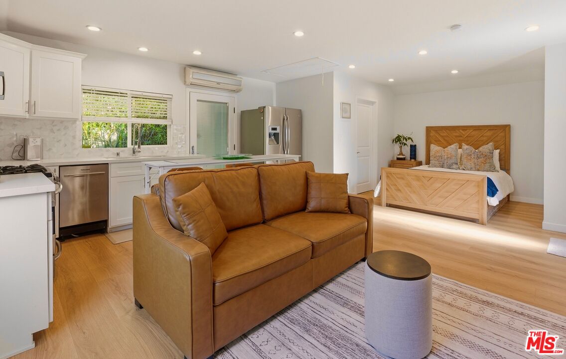132 North Carson Road, Unit A Beverly Hills, CA 90211 - Photo 8 of 14 a living room with furniture and a large window