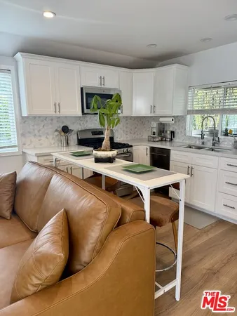 a kitchen with stainless steel appliances granite countertop a sink and a stove