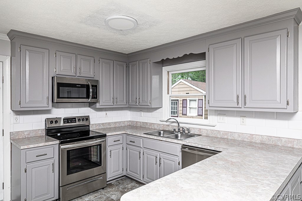 14209 Long Hill Road Midlothian, VA 23112 - Photo 12 of 50 a kitchen with a sink stove and microwave