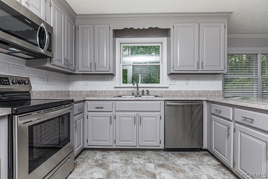 14209 Long Hill Road Midlothian, VA 23112 - Photo 16 of 50 a kitchen with stainless steel appliances granite countertop a sink stove and microwave