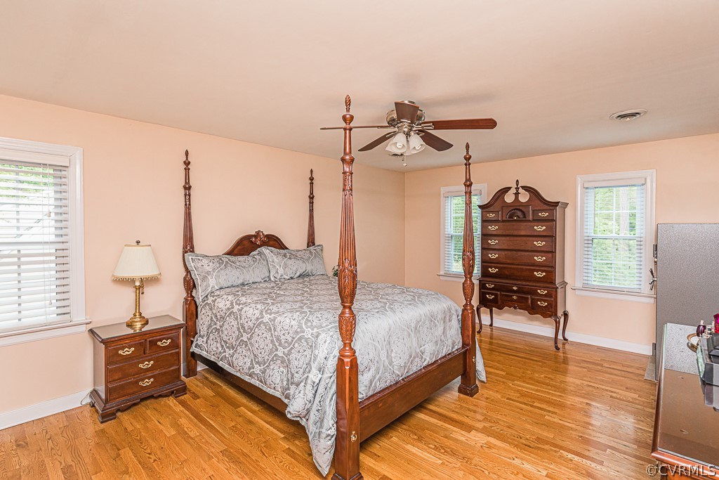 14209 Long Hill Road Midlothian, VA 23112 - Photo 28 of 50 a bedroom with a bed and dresser with wooden floor