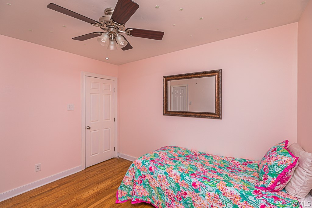 14209 Long Hill Road Midlothian, VA 23112 - Photo 36 of 50 a bedroom with a bed and a chandelier