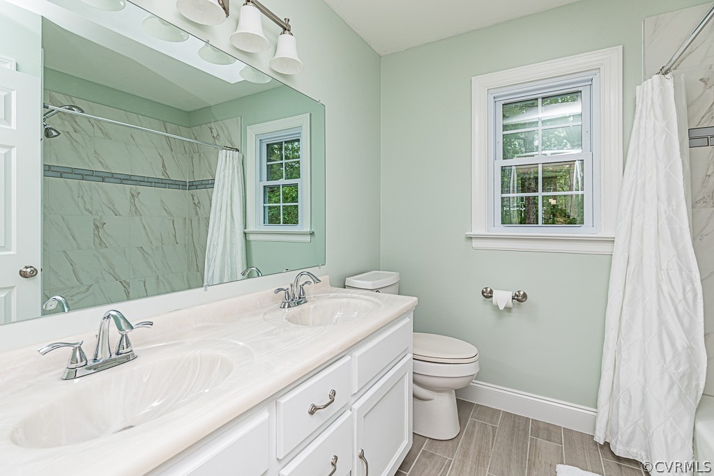 14209 Long Hill Road Midlothian, VA 23112 - Photo 40 of 50 a bathroom with a granite countertop sink a toilet and shower