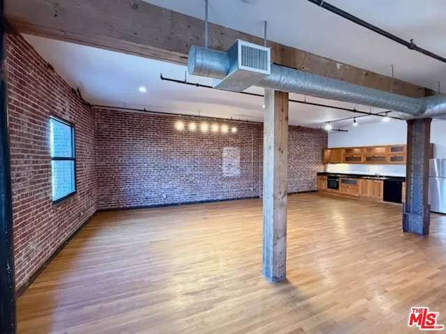 a view of a room with wooden floor